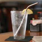 9" bent stainless steel straw in glass of ice water